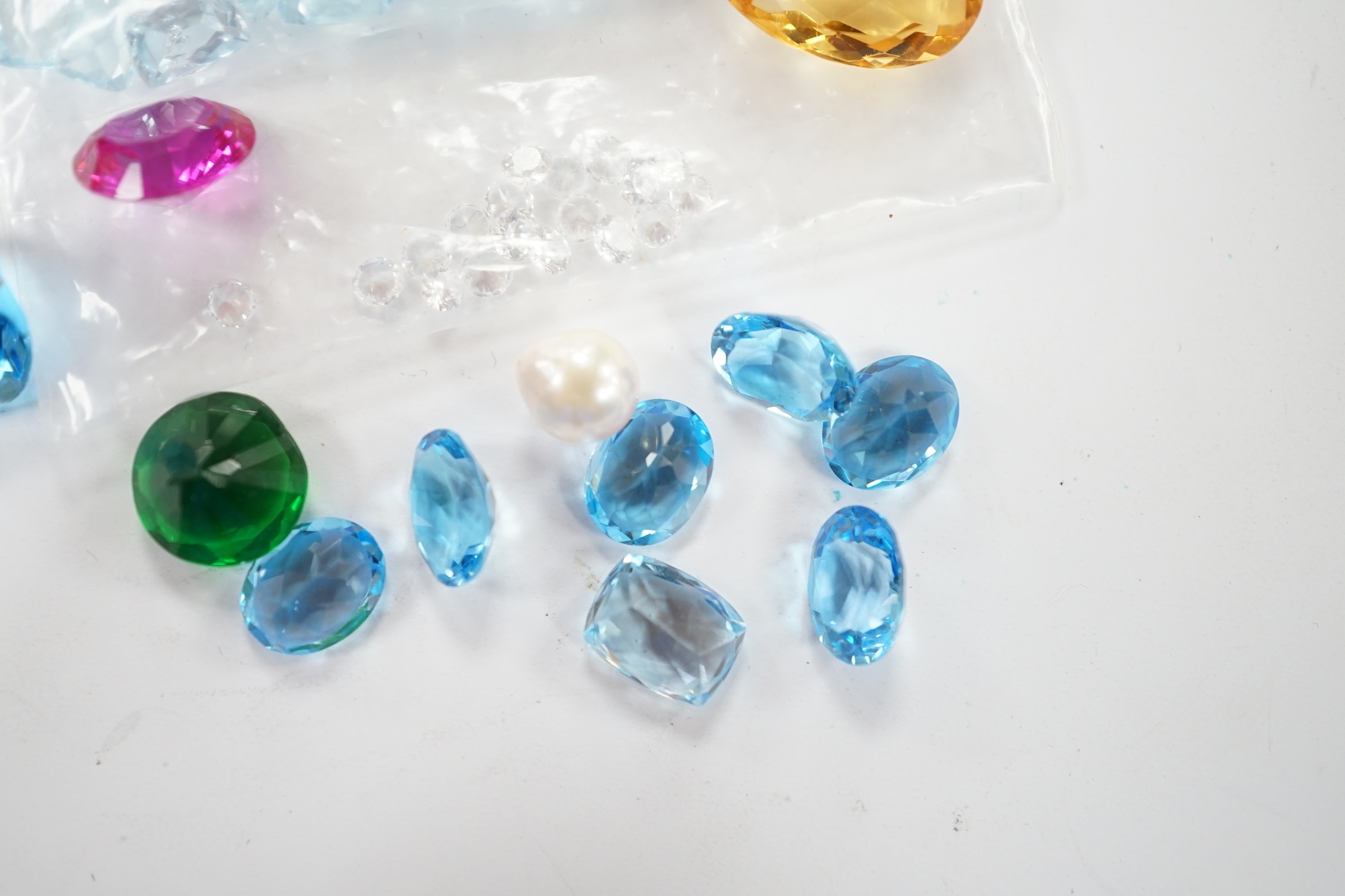 A small quantity of unmounted cut gemstones including diamonds and aquamarine. Fair condition.